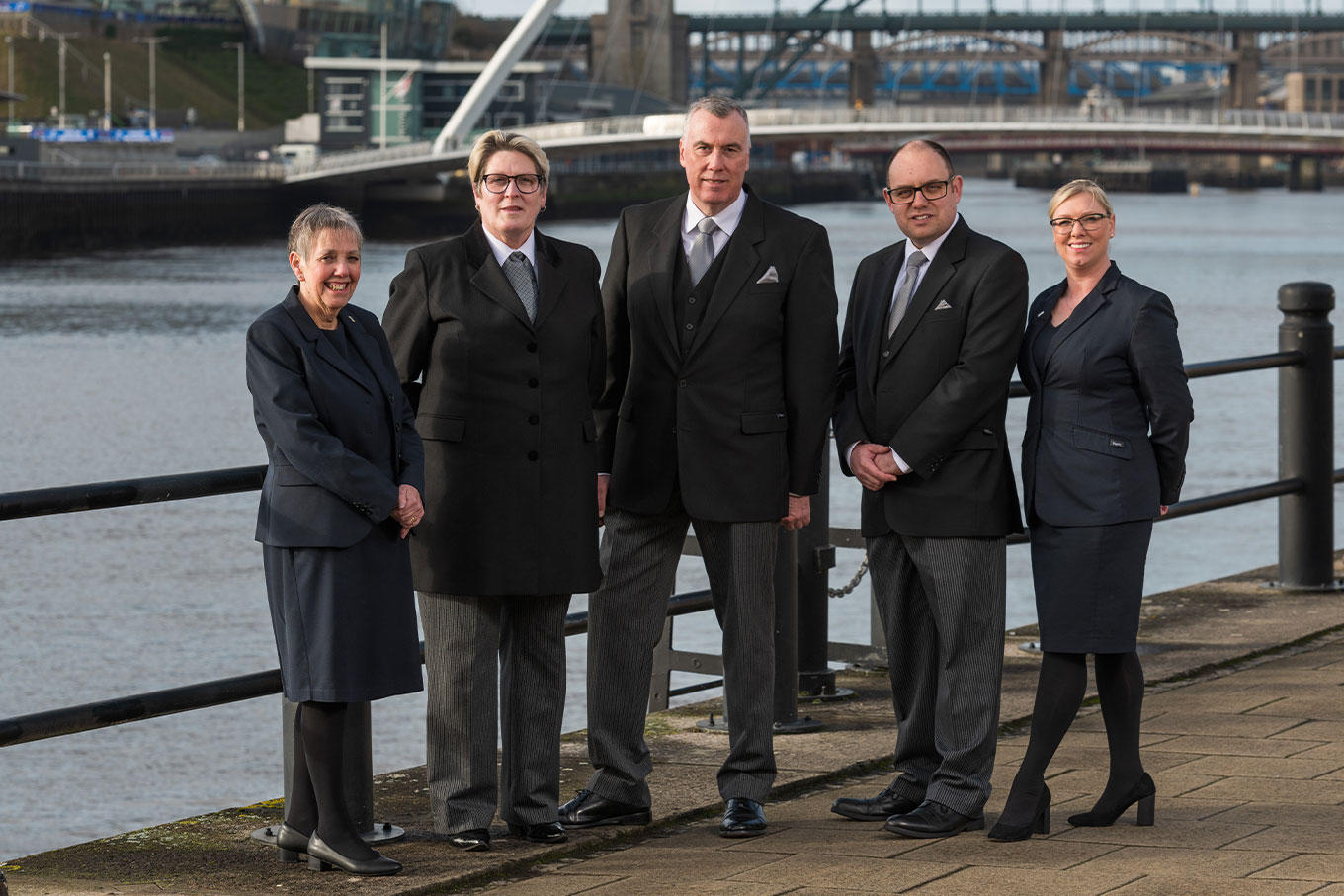The team from WS Harrison funeral directors stand together outside